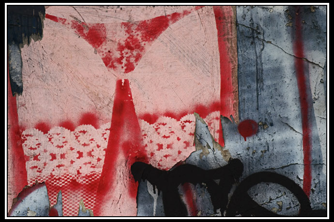 torn poster and grafitti